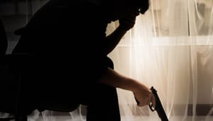 Foto van depressieve man met pistool in hand